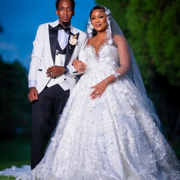 "Intricate lace wedding dress with a voluminous ruffled tulle train - Rebirth Couture Bespoke.